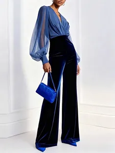 Elegant blue wide-leg jumpsuit with chiffon top and high-waist velvet trousers.