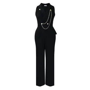 Front detail of black blazer collar jumpsuit featuring decorative gold chain accents