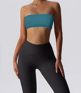 Women's teal strapless tube top sports bra paired with black high-waisted leggings