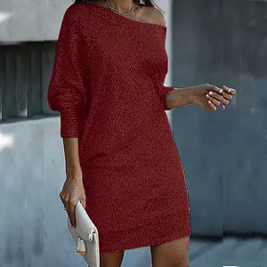 Elegant detail of burgundy sequined one-shoulder dress with long sleeves for party.