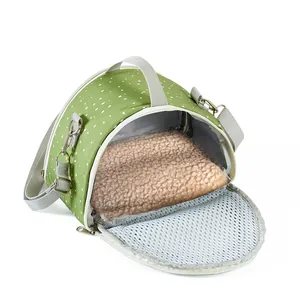 Detailed view of small pet carrier featuring plush interior and mesh ventilation window