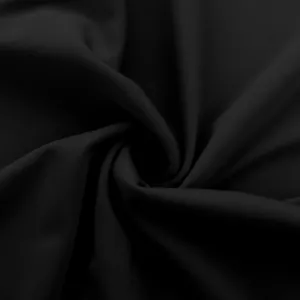 Macro detail showing the smooth texture and high elasticity of black yoga pants fabric