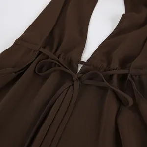Close-up of brown chiffon halter top detail with adjustable tie waist design