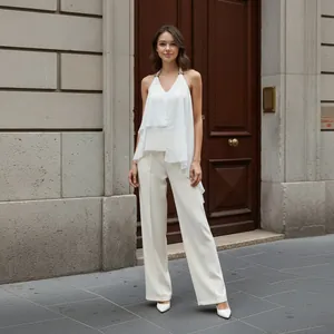 Elegant French-style halter-neck chiffon top with asymmetric hem and white wide-leg pants