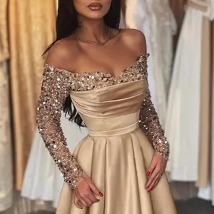 Elegant champagne sequined off-shoulder evening gown with long sleeves for formal galas