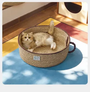 Close-up of a woven seagrass cat bed and scratcher with a cat resting inside.