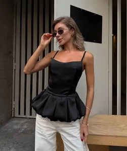 Stylish black satin peplum camisole top featuring delicate spaghetti straps and a ruffled hem