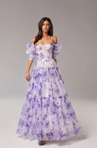 Ethereal off-the-shoulder organza floral evening gown with puff sleeves and a tiered skirt.