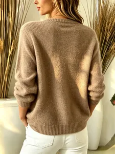 Back detail of a solid brown knit cardigan showing the soft texture and ribbed hem