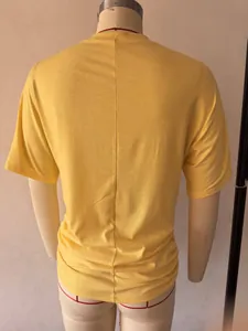 Back view of yellow slim-fit T-shirt for women with vertical seam and gathered hem detail