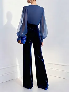 Elegant navy blue velvet wide-leg jumpsuit with sheer sleeves and waist-cinching design