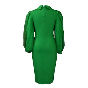 Detailed back view of the green pencil dress showing the zipper and puff sleeve shape.