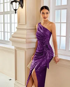 Detailed view of sparkly purple one-shoulder sequin dress with waist tie and high slit.