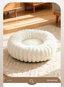 Close-up of plush white pet bed with textured ribbed design in a warm room