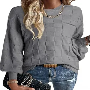 Detail view of grey women's knit sweater featuring unique block pattern texture and pocket