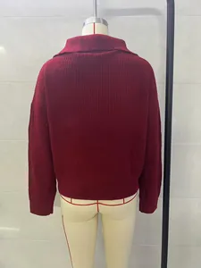 Detailed back view of a loose oversized burgundy ribbed knit sweater with long sleeves