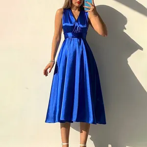 Detail of elegant royal blue satin V-neck dress with high waist and backless design
