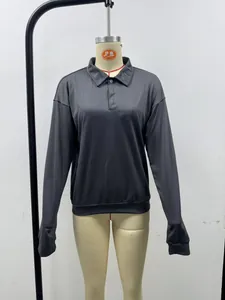 Detailed view of a dark gray men's casual long sleeve polo shirt on a mannequin