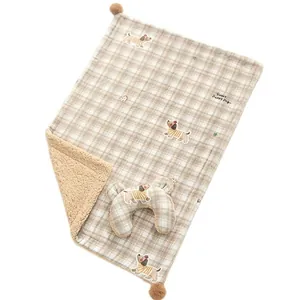 Plaid pet blanket and pillow set with cute cartoon dog illustrations and soft sherpa lining.