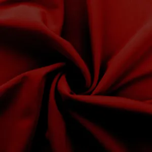 Detailed macro shot of dark red high-stretch fabric texture for yoga pants