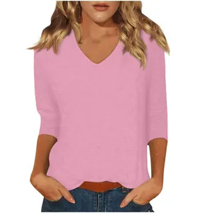 Casual women's solid pink V-neck T-shirt featuring stylish three-quarter length sleeves.