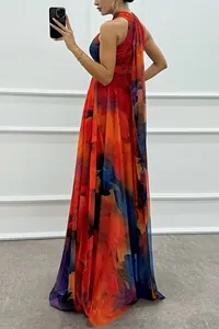 Elegant side view of a sleeveless halter neck maxi dress with vibrant abstract print