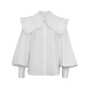 Detailed front view of a white French-style blouse with a ruffled doll collar and puff sleeves