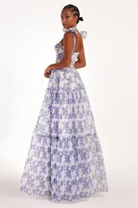 Elegant floral organza maxi dress with bow straps and a tiered full skirt design.