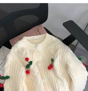Cream cable knit cardigan with 3D cherry poms detail