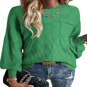 Macro view of green knit sweater detailing the textured checkered pattern and rib cuffs