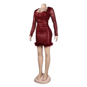 Detail of a sparkling red sequin bodycon mini dress featuring a luxurious feather trim hem