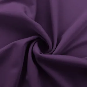 Close-up macro view showing the soft texture of purple stretchy fabric for yoga pants