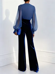 Elegant blue jumpsuit with sheer puff sleeves and velvet wide-leg trousers back view.