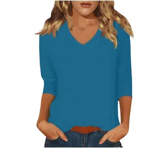 Detailed view of a women's casual solid blue V-neck T-shirt with 3/4 sleeves.