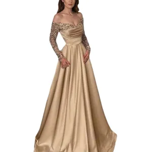 Champagne gold sequined long sleeve off-the-shoulder evening gown with satin skirt