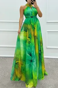 Detail shot of a halter-neck maxi dress with a vibrant green and yellow floral print
