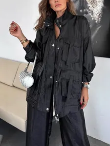 Stylish women's solid black utility jacket featuring multi-pocket design and a loose fit.