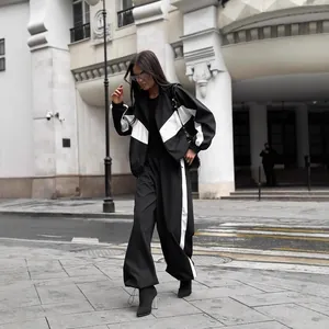 Chic women's black and white color-block tracksuit with zip-up jacket and wide-leg pants
