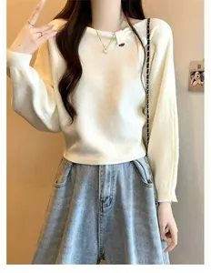 Detail of a Korean-style off-white sweater with an asymmetric pleated neckline