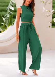 Model wearing a dark green two-piece ribbed knit set with sleeveless top and wide-leg pants
