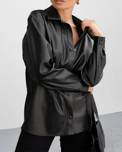 Detailed shot of a vintage black PU leather jacket showing soft texture and snap buttons