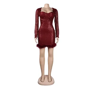 Detail view of a sparkling burgundy sequin bodycon dress with ostrich feather trim.