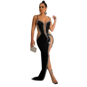 Full view of sexy black rhinestone spaghetti strap evening dress with mesh cutout and slit