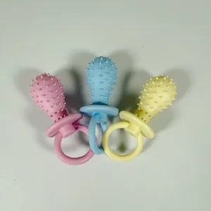 Set of three colorful pacifier-shaped TPR dog chew toys for puppy dental health.