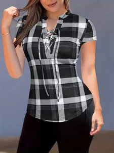 Detailed view of the plaid print and front lace-up design on this slim fit women's top