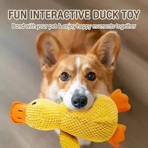 Cute yellow plush duck squeaky dog toy held by a Corgi dog for interactive play