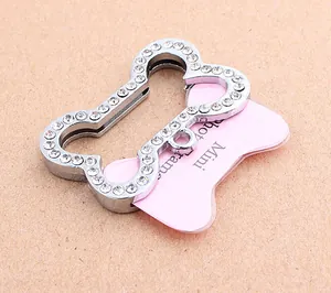 Close-up of a bone-shaped rhinestone pet ID tag with a pink mini photo frame insert