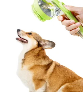 Detail view of a handheld green pet shower brush with shampoo dispenser being used on a dog