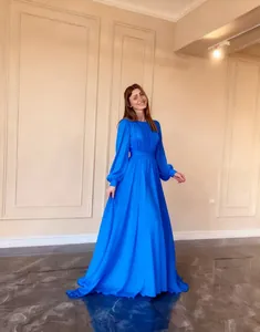 Elegant royal blue French chiffon maxi dress with long sleeves and flowing skirt detail.