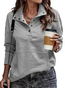 Detail view of casual grey sweatshirt featuring a button-up collar and ribbed cuffs.